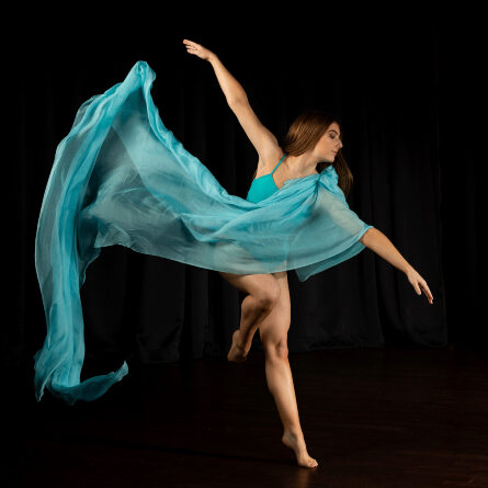 Woman in a blue dress dancing